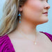 a profile view of a young lady wearing jewelry