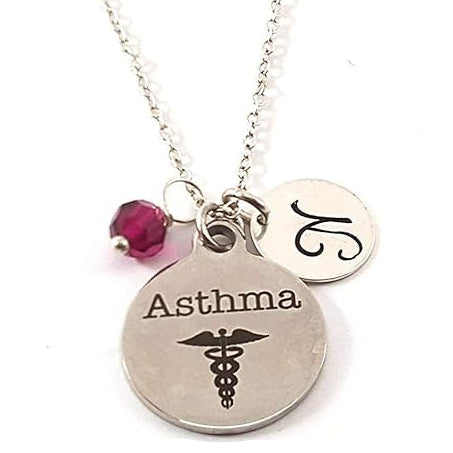 Necklace with 'Asthma' pendant and red bead on a white background