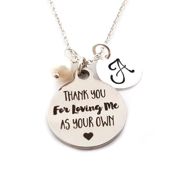 Necklace with a pendant that reads 'Thank you for loving me as your own' on a white background