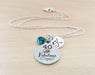 40 and fabulous personalized necklace displayed in a swirl on a wooden background