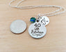 40 and fabulous personalized necklace next to a USD quarter on a wooden background