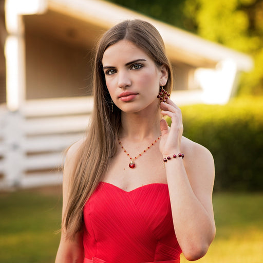Woman in a red dress standing outdoors with a blurred background