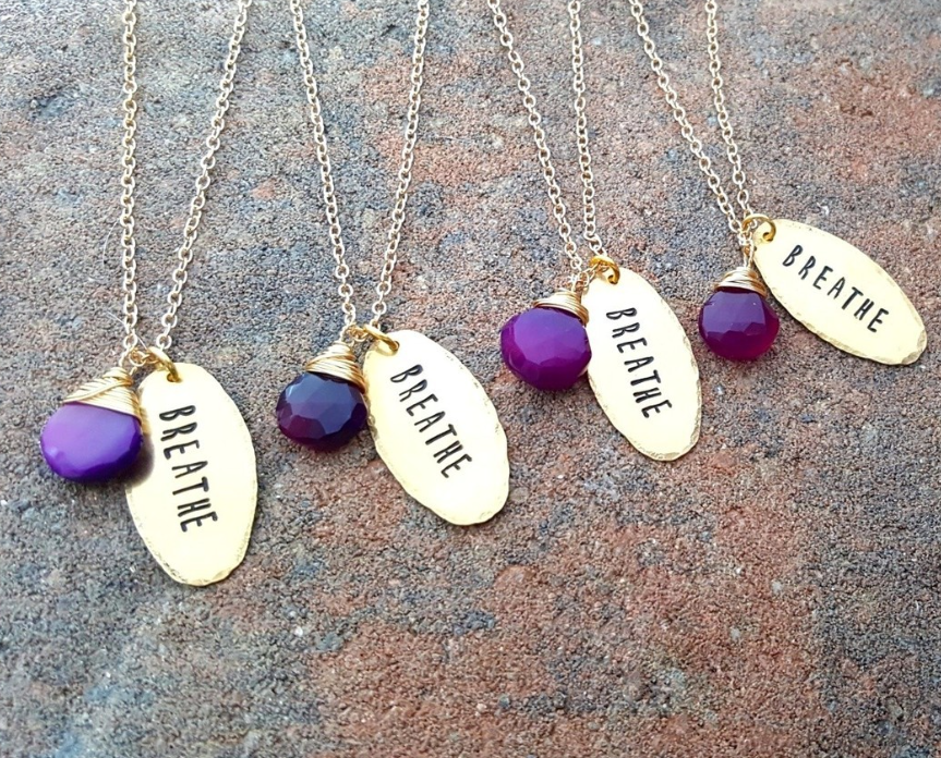 Hand-stamped "Breathe" brass necklace with purple chalcedony charm