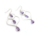 A pair of handcrafted silver and amethyst dangle earrings featuring a unique, organic wire frame design. Each earring has three faceted teardrop-shaped amethyst gemstones, wire-wrapped and suspended from delicate silver ear hooks. The background is a bright, clean white