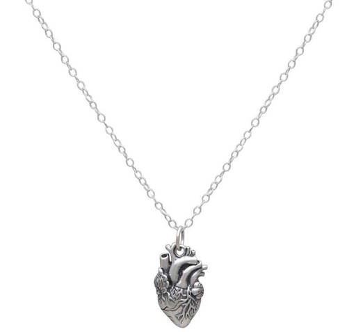 Close-up of sterling silver anatomical heart charm showing realistic detailed design