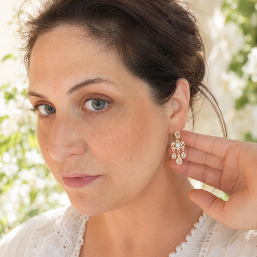 Woman wearing a silver earring with a blurred natural background