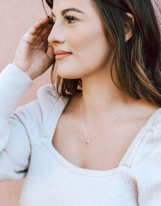 Personalized birthstone jewelry gift for women – disc charm necklace photographed on model's neck.