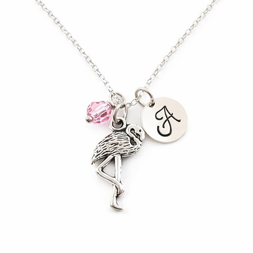 Necklace with flamingo charm, pink bead, and initial charm on a white background