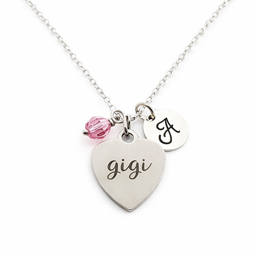 Necklace with heart-shaped 'gigi' charm and pink bead on a white background