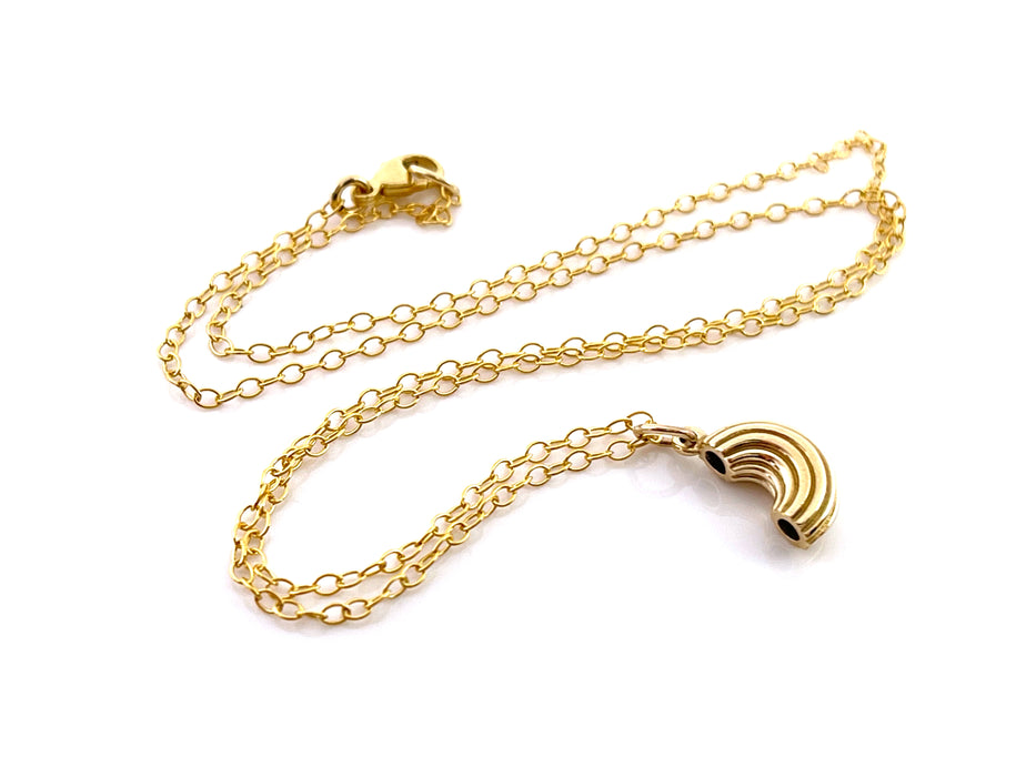 gold macaroni noodle charm necklace flatlay on solid white background