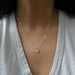 close up of woman wearing gold texas necklace
