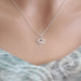 Silver lotus flower necklace on a mannequin with a light background