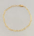 Gold heart chain bracelet on a light gray background