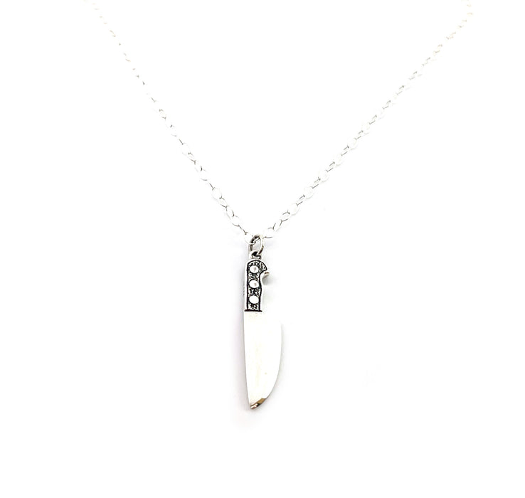 knife harm on sterling silver chain on white background