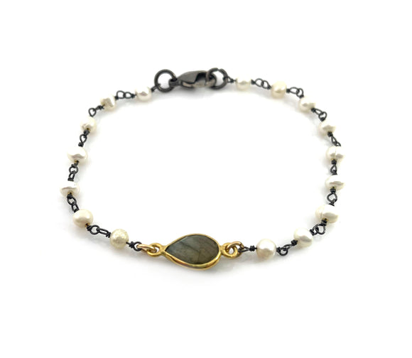 oxidized wire wrapped pearl bracelet on white background