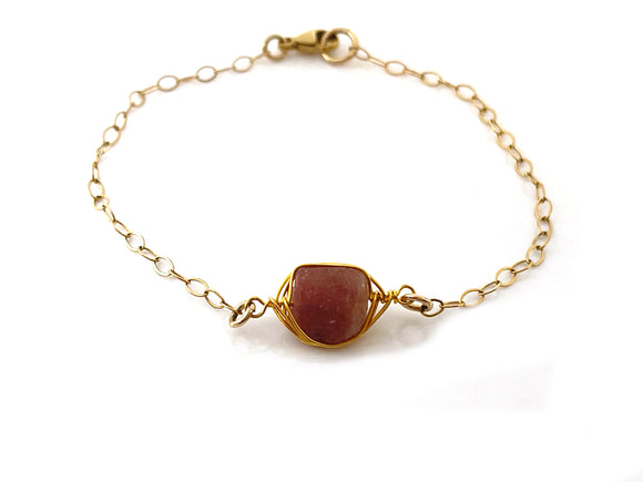 pink tourmaline gold bracelet on a white background