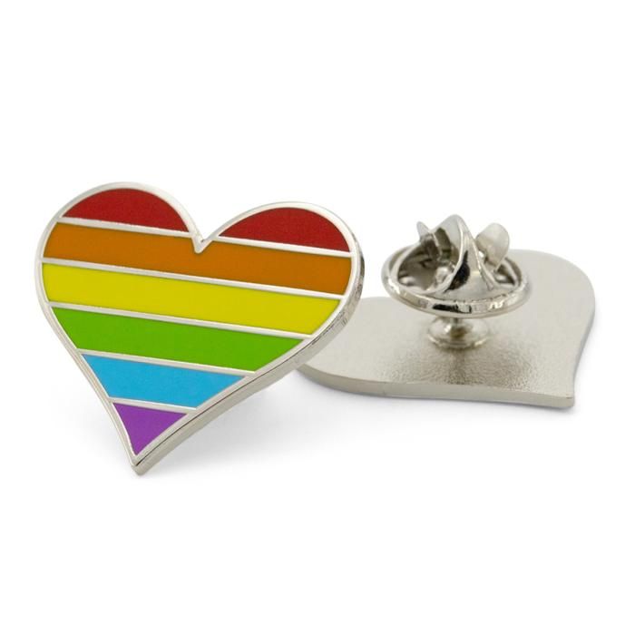 Rainbow heart-shaped pin with metal backing on a white background