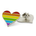 Rainbow heart-shaped pin with metal backing on a white background