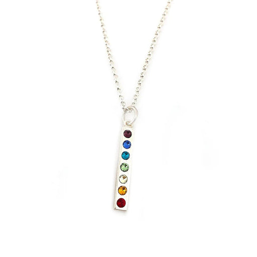 close up of a silver vertical bar pendant with a row of rainbow crystals hanging from a silver chain