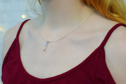 rainbow chakra silver necklace on a model