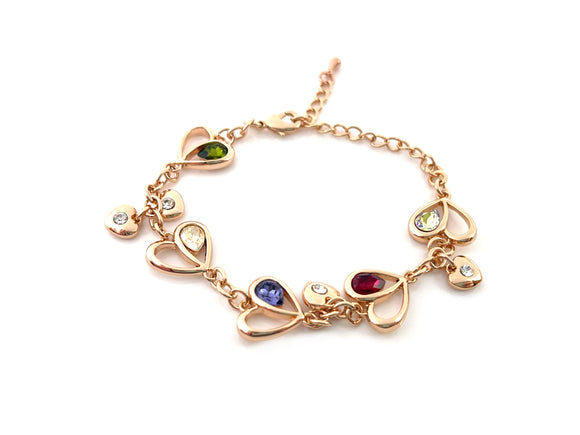 rose gold heart bracelet with green, white, blue and red rhinestones on white background