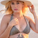 Woman in a bikini and sun hat on a beach