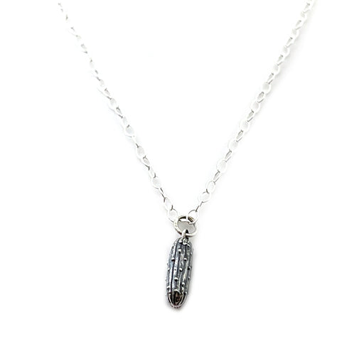 sterling silver pickle charm necklace on white background