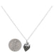 strawberry silver charm hanging on a silver cable chain next to a USD dine to demonstrate size