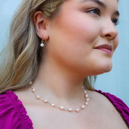 wire wrapped freshwater pearl necklace and simple handmade pearl drop earrings on a model profile view