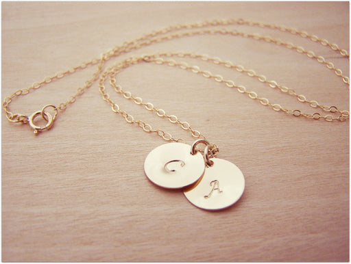 Close-up of 14k gold filled hand stamped initial discs on personalized monogram necklace
